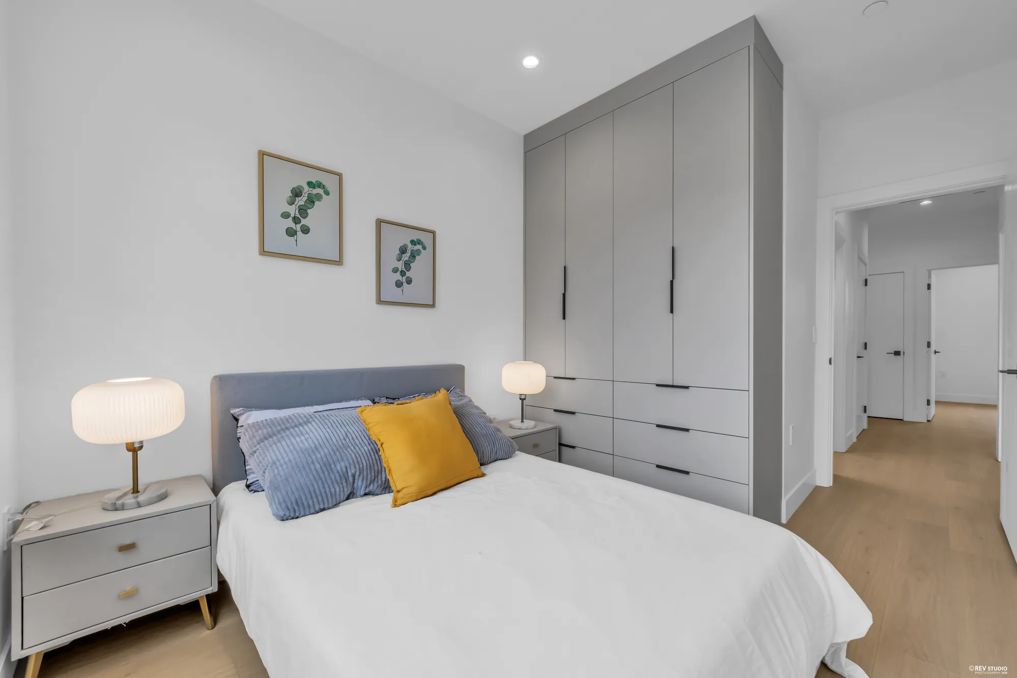 The same bedroom showing a full-height built-in wardrobe beside the bed