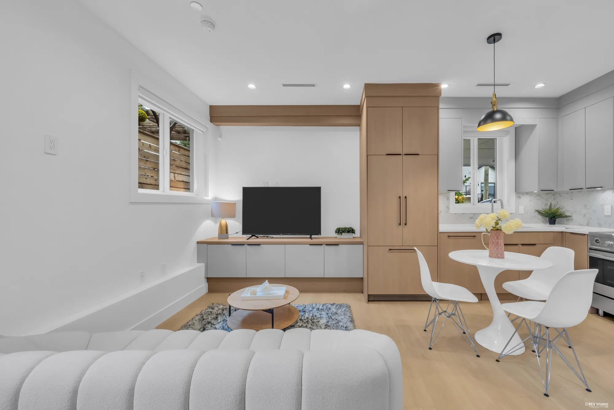 The same room from the far end, showing the dining table and kitchen