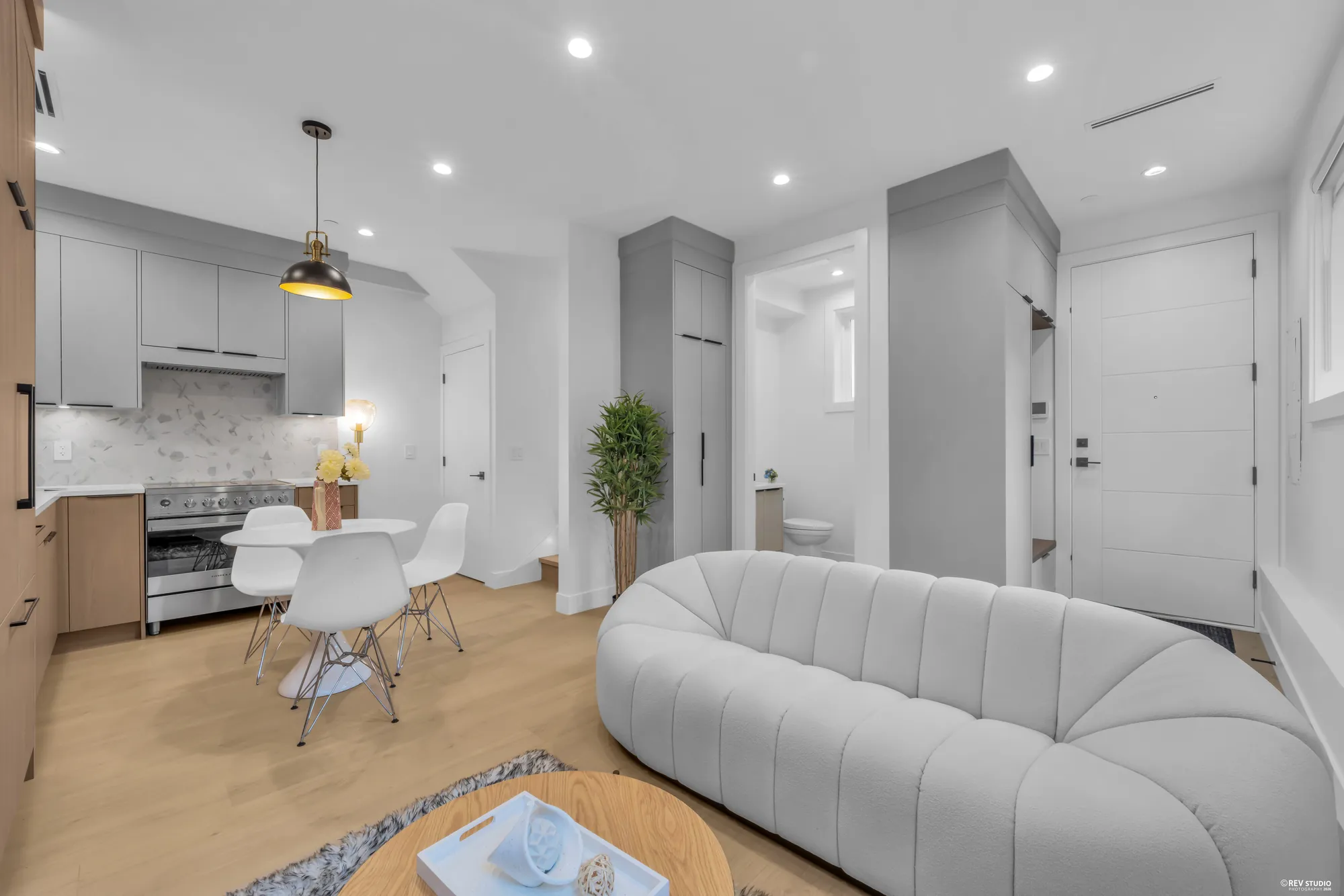 Looking back across the sofa toward the front door and the kitchen