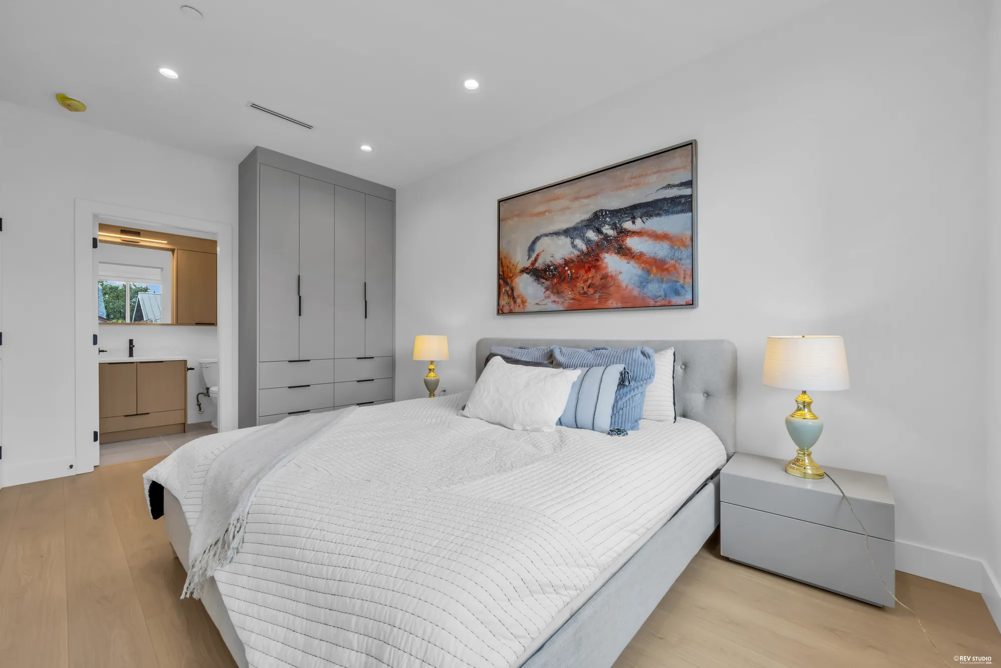 The primary bedroom from the door, showing the wardrobe wall and the ensuite beyond